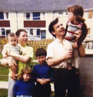 Harry and Bridie Duffy with some of their kids outside their home in Creggan.