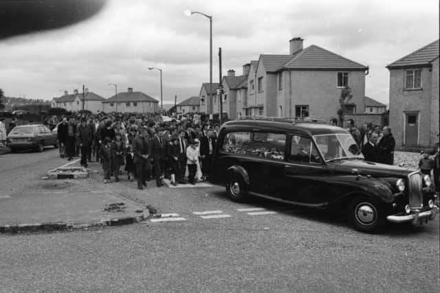 Harry Duffy's funeral makes its way to the City Cemetery. His children, some of them wearing their First Communion outfits, head the cortege.