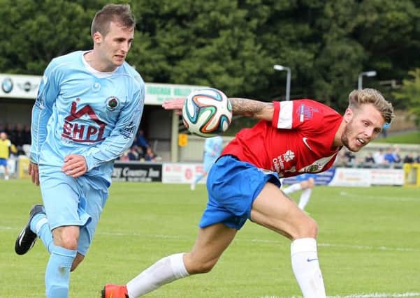 Linfield's Kirk Miller tussles with Institute's Stephen Curry during Saturday's game at the Riverside Stadium. Picture by Brian Little/Presseye