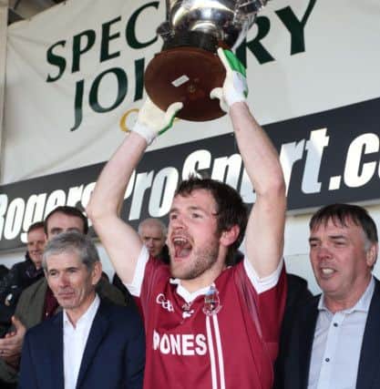 Slaughtneil's captain Francis McEldowney holds aloft the Derry Senior Football Championship trophy.(Photo Lorcan Doherty / Presseye.com)