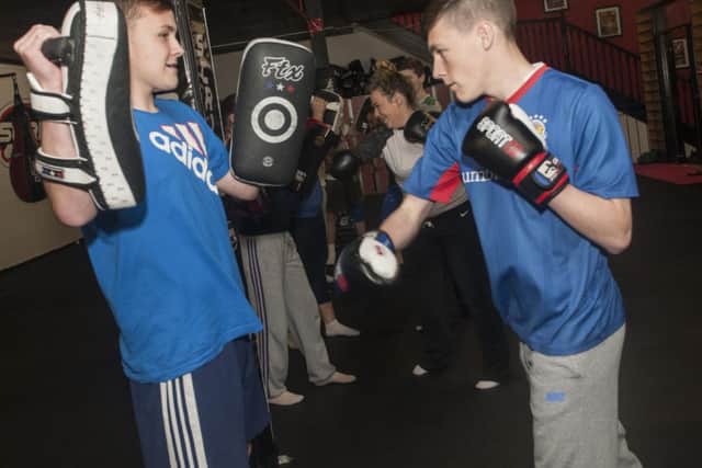 Kaolan McKnight, left and Bradley Baker, do some pad work at the Fight for Peace programme at Strike Martial Arts Academy. (DER-47-2111-GMI-02-STRIKE)