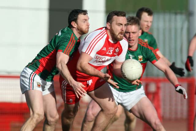 Derry's Emmet McGuckian takes on Mayo's Keith Higgins and Kevin Keane.( Lorcan Doherty / Presseye.com)