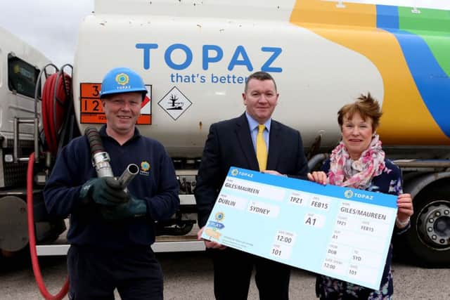 Maureen Giles, winner of the Topaz Play or Park Sydney Opera House Experience, with James McKee, General Manager of Topaz Direct NI (left). The prize, worth ¬15,500, includes 10 nights stay in luxury accommodation overlooking the iconic Sydney Opera House, Sydney, Australia plus ¬3,000 spending money. Included is local Topaz delivery driver, Nigel Tweed. (Submitted picture)