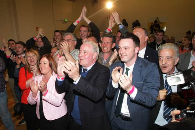 The SDLP supporters celebrate Mark Durkan's victory at Templemore Sports Complex last night. DER1815MC119