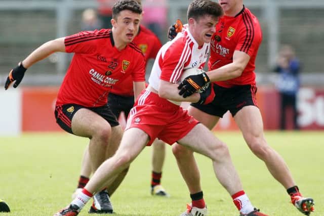 Derry's Eoghan Colcannon comes under pressure from Down's Darragh Connolly and Pierce Laverty in Celtic Park. (Photo: Lorcan Doherty / Presseye.com)
