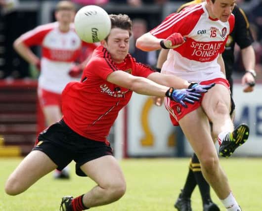 Derry's Shane McGuigan gets his shot away despite pressure from Down's Dean McLaughlin. (Photo Lorcan Doherty / Presseye.com)