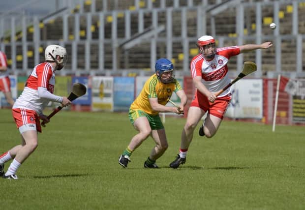 Derry's Alan Grant wins this race for the ball during Sunday's Ulster Championship match against Donegal. DER2515-143KM