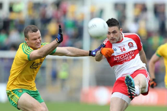 Eoin Bradley gets his shots away despite pressure from Donegal's Neil McGee in Saturday's Ulster semi-final. (
Picture by Andrew Paton / PressEye.)