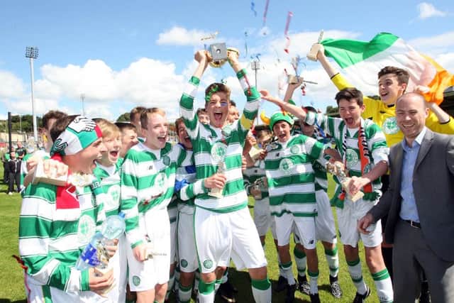 Celtic players celebrate after receiving the trophy. Included is Jonathan Robinson, Hughes Insurance.   Photo Lorcan Doherty Photography