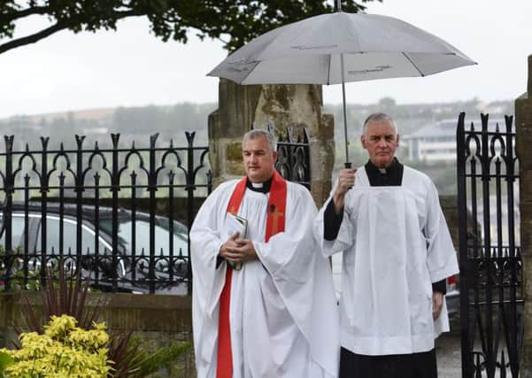 Rev Malcolm Ferry, Rector of St Augustine's Parish Church, where Marlene Jefferson was a member, and Fr Michael Canny, who participated in the funeral service, arrive at St Augustine's Church on Wednesday. INLS3415-102KM