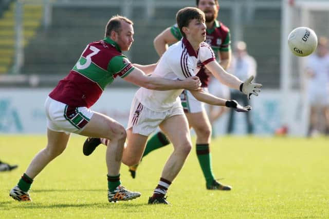 Slaughtneil's Paul McNeil takes on Coleraine's Ciaran McGoldrick in Celtic Park.

(Photo Lorcan Doherty / Presseye.com_