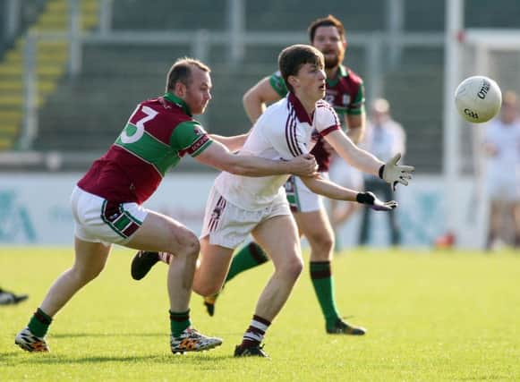 Slaughtneil's Paul McNeil takes on Coleraine's Ciaran McGoldrick in Celtic Park.
(Photo Lorcan Doherty / Presseye.com_