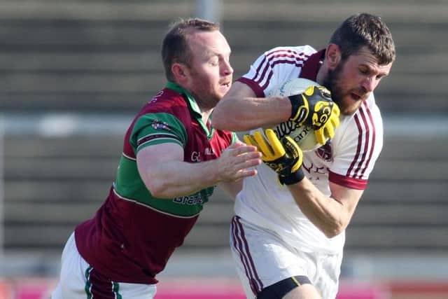 Slaughtneil's Frank McEldowney and Coleraine's Ciaran McGoldrick.

(Photo Lorcan Doherty / Presseye.com)