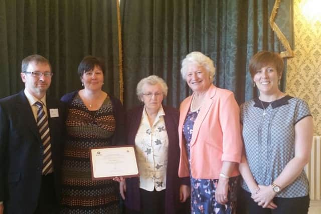 Craig's family receive the Order of St John Award from Dame Mary Peters, second from right. Included are Jeremy and Alexia McCook, Jean McCook and Dianne McCook.