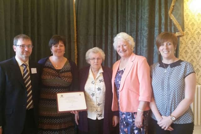 Craig's family receive the Order of St John Award from Dame Mary Peters, second from right. Included are Jeremy and Alexia McCook,  Jean McCook and Dianne McCook.