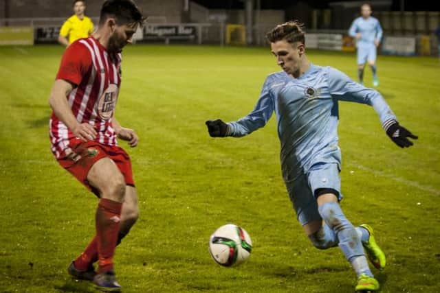 Institute's Gareth Brown attempts to pass his marker during Wednesday night's League Cup clash at Drumahoe against Warrenpoint. DER4615MC035