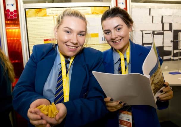 Rebecca Wright and Lauren McCallion from St Mary's College and their project 'Investigating the effet of reheating pasta on the rate of digestion of it's starch by amylase' at the BT Young Scientist & Technology Exhibition 2016 in the RDS Dublin.