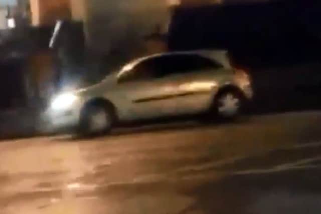 An image taken from the video that appears to show a car being driven recklessly up and down the Strand Road.