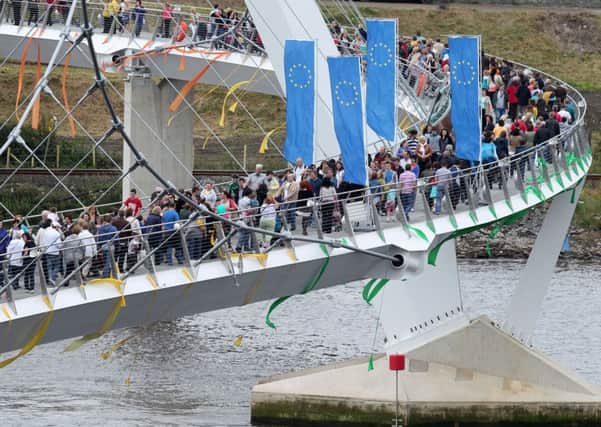 People crossing the European Union funded Peace Bridge after it was opened by the EU Commissioner for Regional Policy Johannes Hahn back in June 2011.  Picture: Michael Cooper