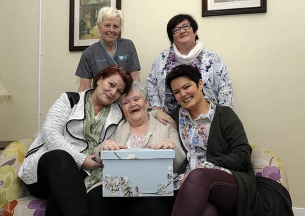 76- year old Anne Mooring, holding her Memory Box, pictured with her daughters Jackie Lees (seated left) and Marie Doherty. Standing is Annes daughter Roisin Cartmill (on the right) and Seymour Care Centre Activities Co-ordinator Maureen McLaughlin. DER0316GS040