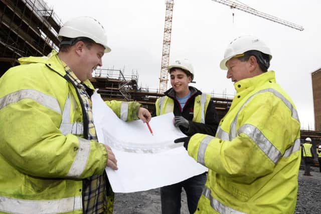 Gerry McBrearty, right, Commission Engineer for the Western Trust, looks over the plans with McLaughlin & Harvey staff members Jonathan Collins and Charlie McGleenan, on the site of the new Radiotherapy Centre. INLS0316-159KM