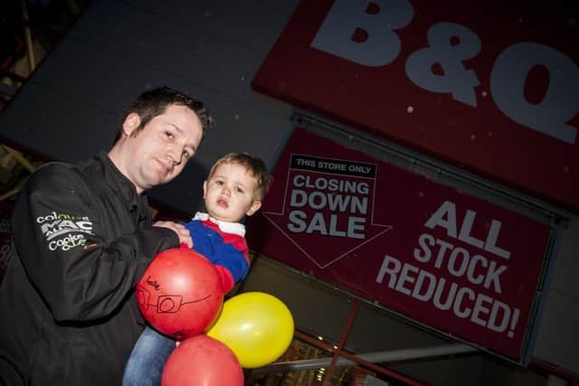 B&Q Deputy Manager Aaron Harte pictured with his son Evan on Saturday, as the shutters came down on the Buncrana Road store for the last time. Aaron worked for the company for over 20 years, seven of those in Derry. DER0216MC041 (Photo: Jim McCafferty)