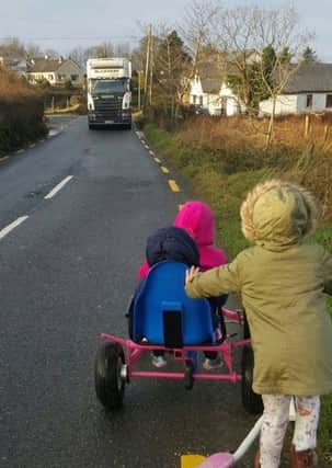 Children and a lorry attempt meet on the notorious Aghilly road, which residents say is a 'death trap.'