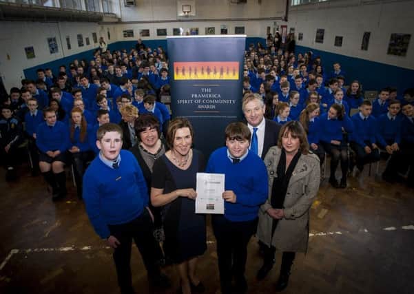 Adrian McMyler, third from right, pictured at his school assembly where he received a Certificate of Achievement. Also included are Rosemary Russell, Pramerica; Rosaleen Grant, Scoil Mhuire principal; Adrian parents Pat and Sandra and Oisin McLaughlin, who was also commended for his volunteer efforts.DER0516MC003