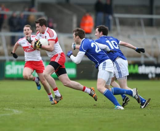 Emmet Bradley takes on Cavan's Gearoid McKiernan and Barry Doyle during the recent McKenna Cup semi-final in Armagh.