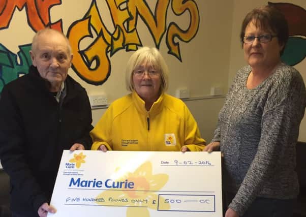 Lexie Stewart presents Lucille Brolly from Marie Curie, Friends of Roe Valley with a cheque from his fundraising coffee morning. Also pictured is Tina McCloskey from Glens Community Association.