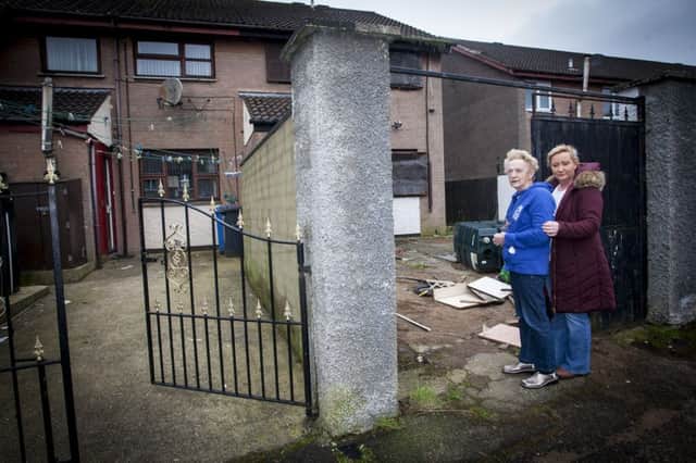 Monica Harkin pictured outside the derelict house next to her own home at Fergleen Park, with neighbour Caroline Lynch, chairperson of Galliagh Community Development. DER0716MC001.
