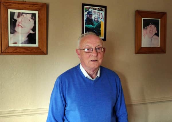 Mickey English pictured in his home in Cable Street last Friday. On the wall, behind Mickey, are pictures of his sons Gary and Charles, who were both killed in Derry during the 1980s. The 30th anniversary of Charles' death is on Thursday August 6 and will be marked with a commemoration at the Lecky Road republican monument at 7pm. The other photo on the wall is of Mickey and his grandson Oscar on the last official Bloody Sunday Commemoration March in January 2011.
