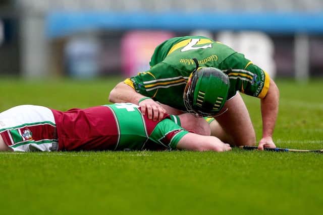 Mark Phelan of Glenmore consoles Colm McGoldrick of Eoghan Rua at the end of the All Ireland Junior Hurling final in Croke Park on Sunday. 
(INPHO/Donall Farmer)