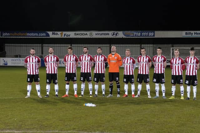 The Derry City team pictured during a minutes silence at the Riverside Stadium Drumahoe, on Tuesday night, in memory of the late Mark Farren.  DER0616GS