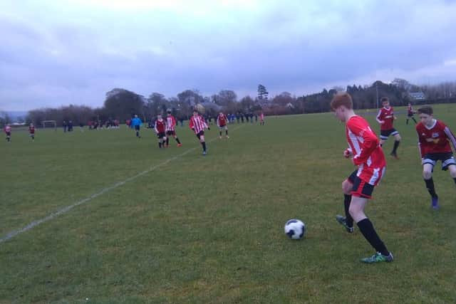 Ruairi McKinney in possession of the ball during Derry Colts' 4-0 win over Maiden City Academy.