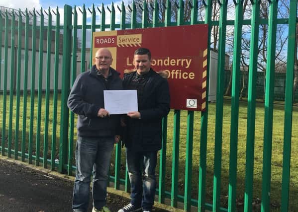 Sinn Fein Councillors, Kevin Campbell (left) and Colly Kelly pictured with the signed petition at TransportNI offices in Derry earlier this week.