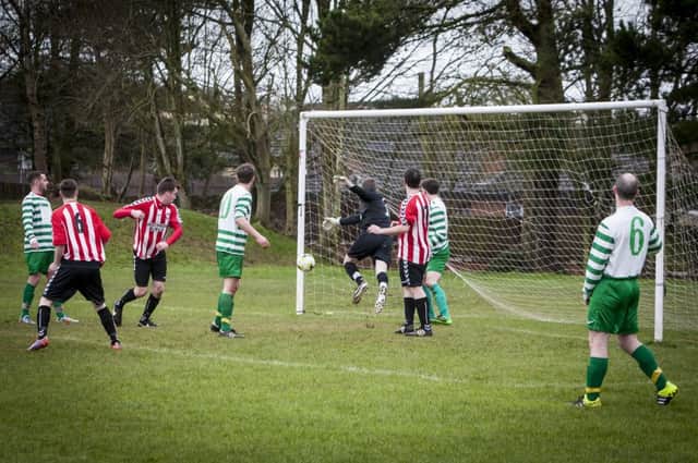 Top of the Hill's JJ McGinley scrambles back in vain as Tristar's Charlie Cusack directs his header inside the post to pull goal back for Tristar on Sunday last. DER1716MC026