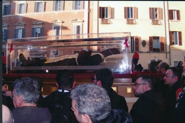 The remains of St Pio are brought through Rome.