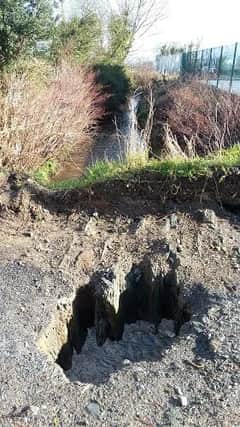 The hole in the road along the border, captured by Grainne McCool.