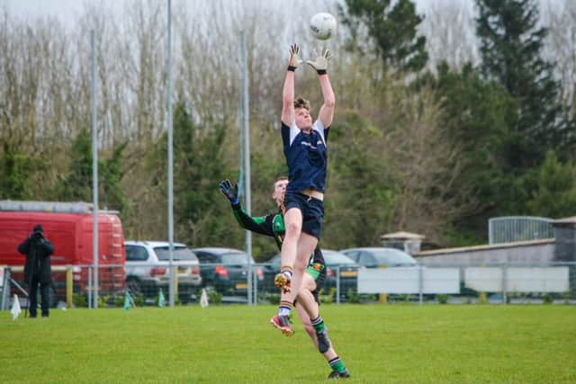 St. Columb's College Eoin McElhinney makes a fantastic high against Holy Trinity on Friday.