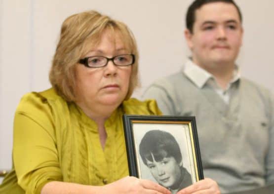 Helen Deery, sister of Manus Deery with a picture of her brother wo was 15 when he was shot dead by the British Army on May 19, 1972.