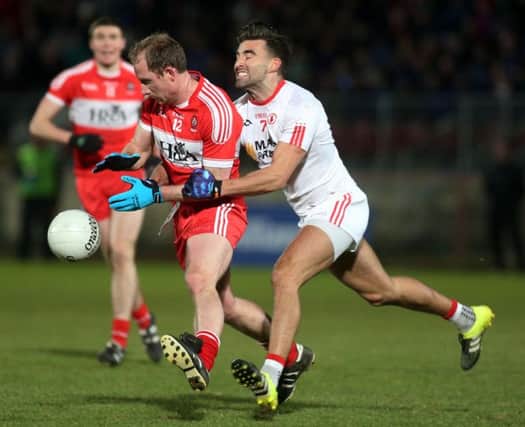 Derry's Sean Leo McGoldrick comes under pressure from Tyrone's Tiarnan McCann during the one sided Division Two clash on Saturday night.


(Photo Lorcan Doherty / Presseye.com)