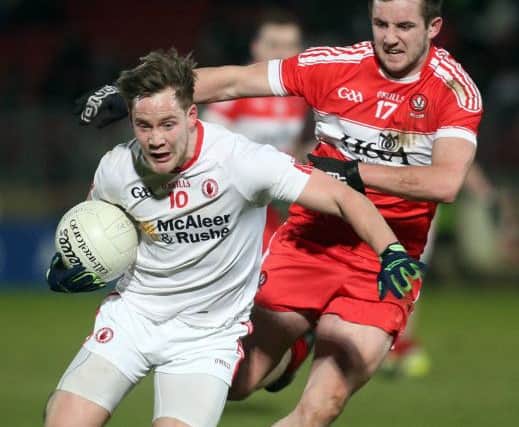 Tyrone's Kieran McGeary tries to hold off Derry's Ryan Ferris in Healy Park on Saturday night.
(Photo Lorcan Doherty / Presseye.com)