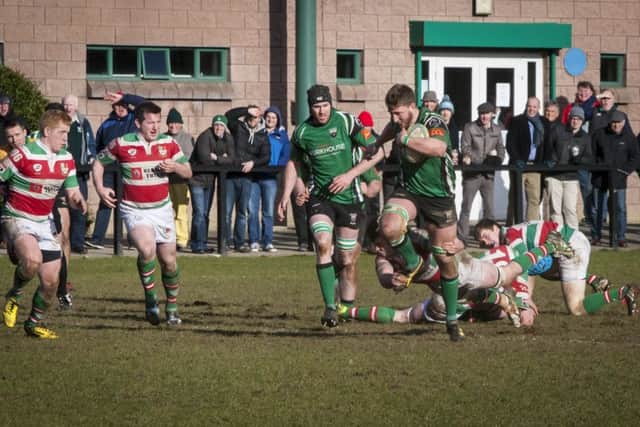 City of Derry's Adam Bratton evades three Sundays Well players during Saturday's clash at Judges Road. DER0916MC026