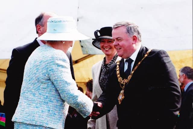 John Dallat, as mayor of Coleraine, shakes hands with the Queen.