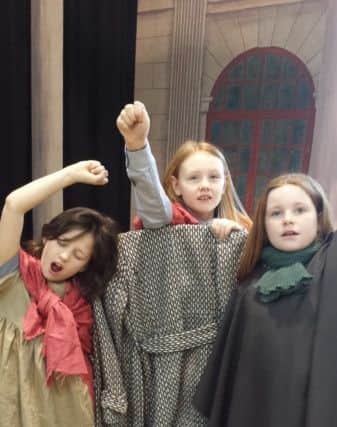Laura Symanzka, Clara Sheridan and Orla Grant as the street children.