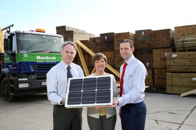 Pictured, from left, with a section of solar panels, are, Gerry Conway, Financial Director, Murdock Builders Merchants; Ann Morgan, CEO Murdock Builders Merchants; and Kevin McCarthy, Business Development Manager, Kingspan ESB.