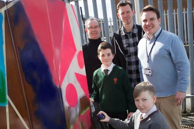Pupils Caolan McGonagle, Oakgrove College and James Devine, St. Joseph's Boys' School spray painting a wardrobe at the launch of the of the 4rs Reuse Schools' Project, funded by the  Housing Executive. Looking on are Eddie Breslin, Housing Executive Good Relations Officer, Donal O'Doherty, graffiti artist, and Richie McRory, 4rs Reuse Workshop.  (Photo - Tom Heaney, nwpresspics)
(Photo - Tom Heaney, nwpresspics)