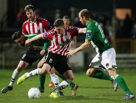 Derry City midfielder Harry Monaghan takes on Cork's Sean Maguire and Karl Sheppard during last week's impressive 1-0 win for the Candy Stripes.

 (Photo Lorcan Doherty / Presseye.com)