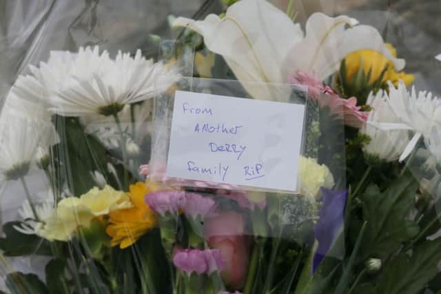 Flowers left at the scene at Buncrana Pier in Co Donegal after five people, including at least two children, have been killed and a baby girl is in hospital after a car they were in slipped from the pier. PRESS ASSOCIATION Photo. Picture date: Monday March 21, 2016. It is understood Garda are treating the incident as an accident and it is thought the car may have "slipped" into the water at around 7.30pm on Sunday. See PA story ACCIDENT Crash Ireland. Photo credit should read: Niall Carson/PA Wire